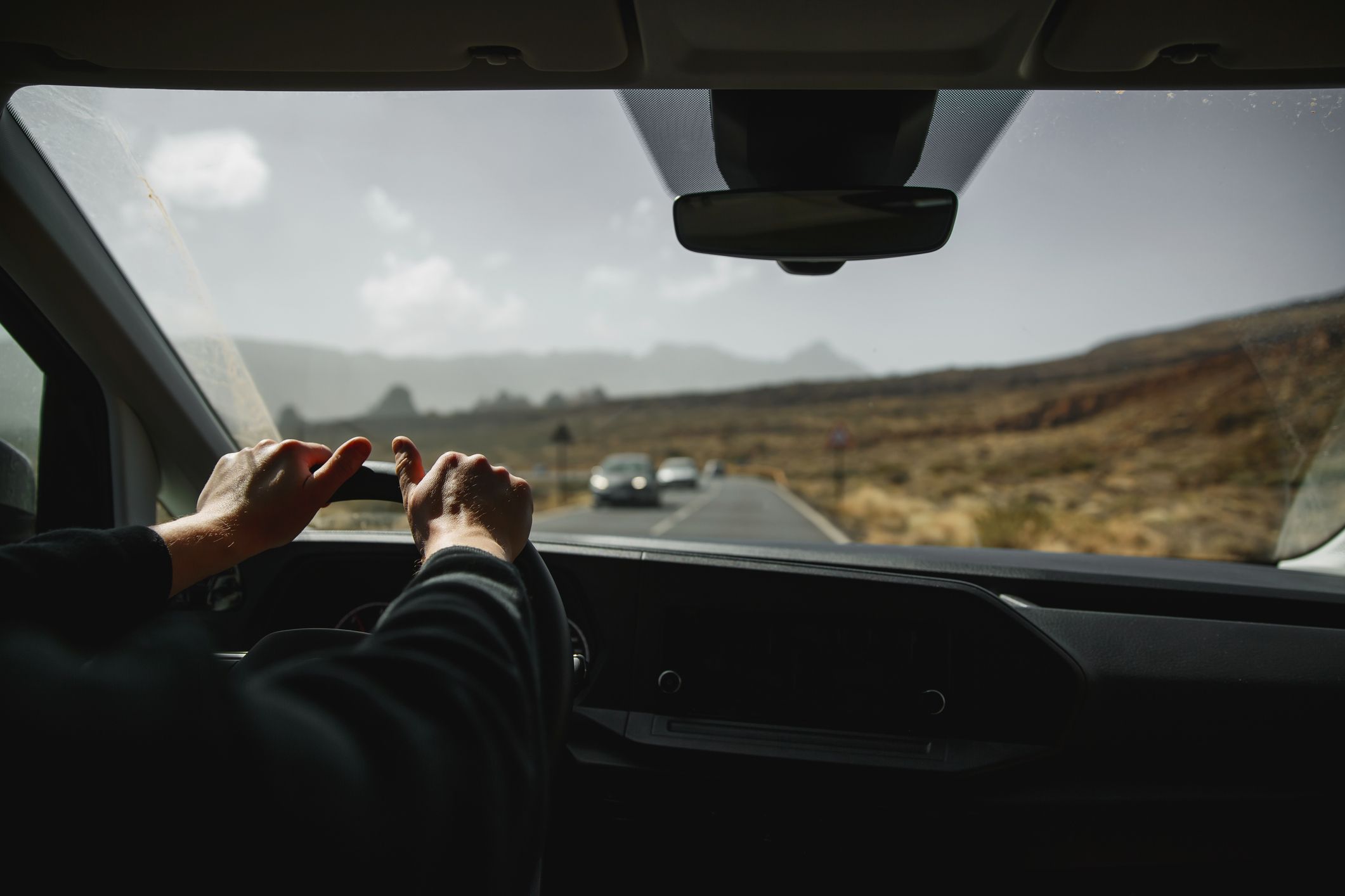 driving down road with rearview mirror