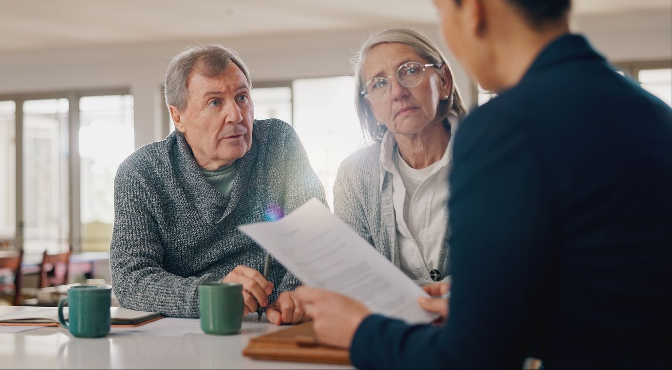 Conversation, documents and senior couple with financial advisor for legacy planning.